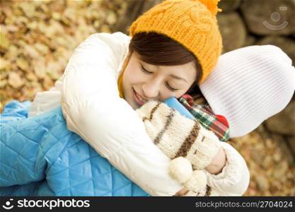 Smiling teenage girl hugging a boy