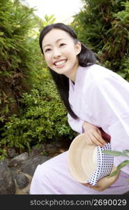 Smiling teenage girl in Japanese garden