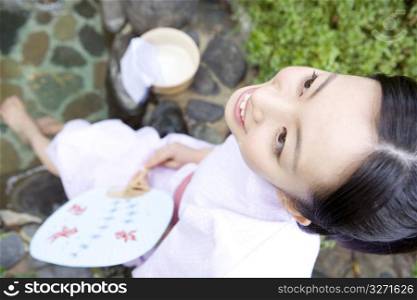 Smiling teenage girl in Japanese garden