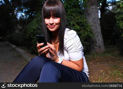 smiling teenage girl shows cell