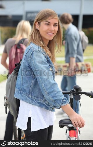Smiling teenage girl with bicycle