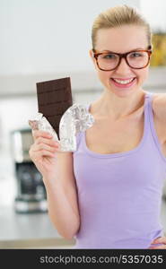 Smiling teenage girl with chocolate bar
