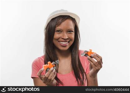 smiling teenage girl with commercial vehicle toys white background