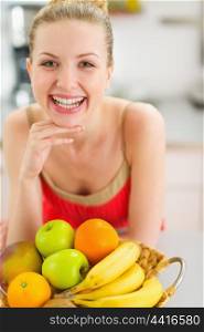 Smiling teenage girl with plate of fruits