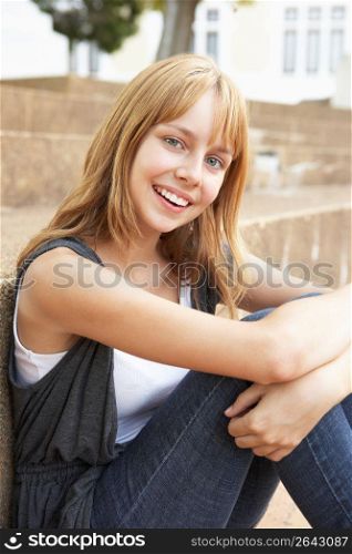 Smiling Teenage Student Sitting Outside On College Steps