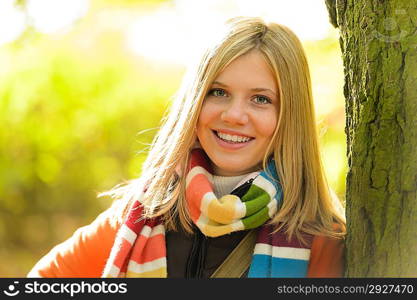 Smiling teenager blonde girl woods tree autumn happy