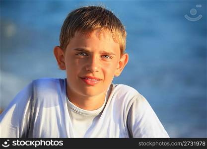 smiling teenager boy against sea
