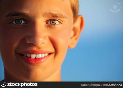 smiling teenager boy against sea