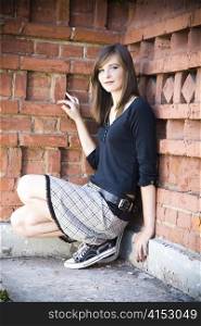 Smiling Teenager Girl Against Brick Wall