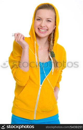 Smiling teenager girl listening music in earphones