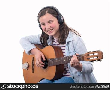smiling teenager girl playing acoustic guitar on white background