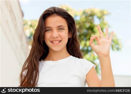 Smiling teenager girl saying ok outside