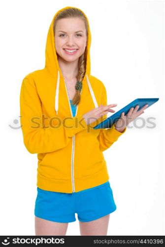 Smiling teenager girl working on tablet pc
