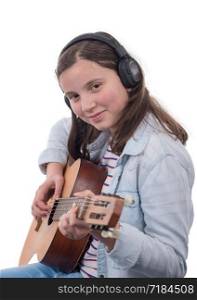 smiling teenager with headphones, playing guitar on white background