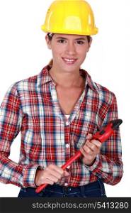 Smiling tradeswoman holding a wrench