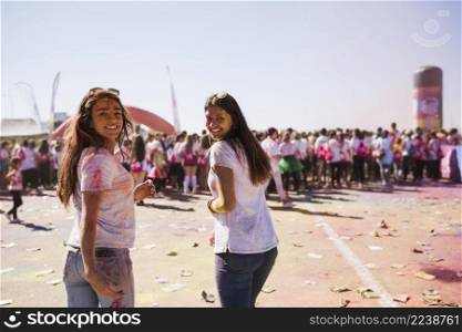smiling two young women enjoying holi festival
