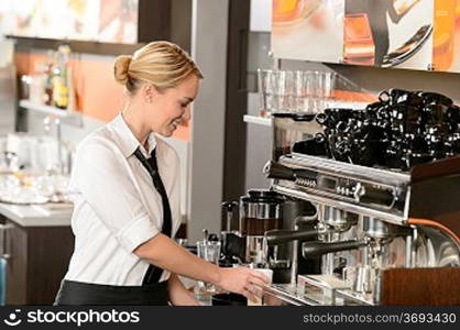 Smiling waitress preparing hot beverage in coffee house