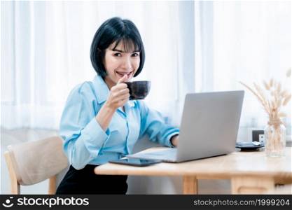 Smiling with dental braces asian freelance people businessfemale hold a coffee cup mug casual working with laptop computer with Notebook and smartphone in coffee shop,Business Lifestyle communication