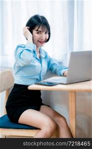 Smiling with dental braces of asian freelance people business female written Notes to on notebook working with laptop computer with coffee cup and smartphone in coffee shop