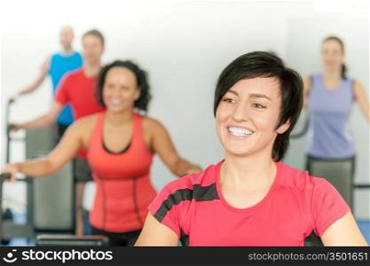 Smiling woman at fitness class gym workout on treadmill
