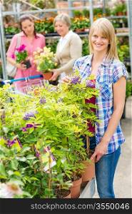 Smiling woman at garden centre shopping for house plants