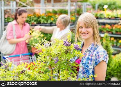 Smiling woman at garden centre shopping for house plants