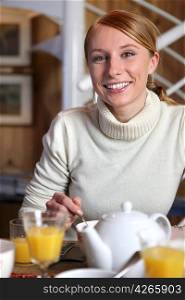 Smiling woman at the breakfast table