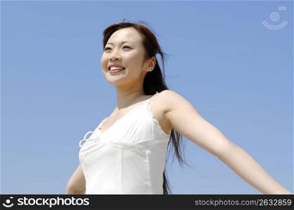 Smiling woman below the blue sky