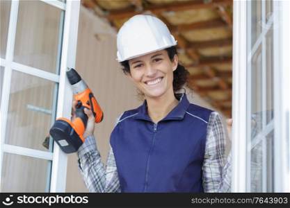 smiling woman builder with building tool