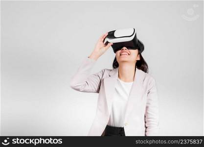 Smiling woman confidence excited wear VR headset device during virtual reality experience isolated white background, Asian happy portrait female playing video game studio shot, copy space