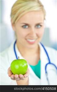 Smiling Woman Doctor in Hospital Holding Green Apple
