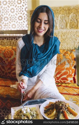 smiling woman eating arab restaurant