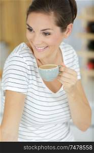 smiling woman holding a cup of coffee