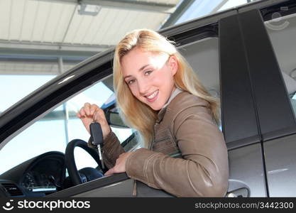 Smiling woman holding brand new car key