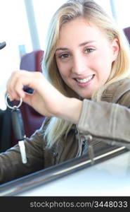 Smiling woman holding brand new car key