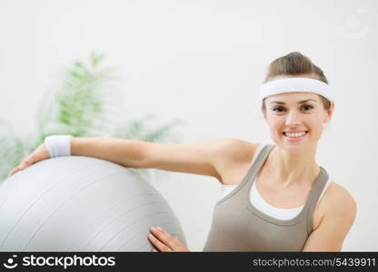 Smiling woman holding fitness ball