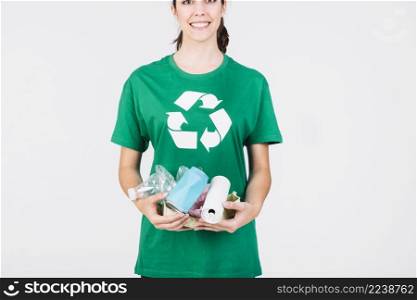 smiling woman holding tin cans plastic bottles