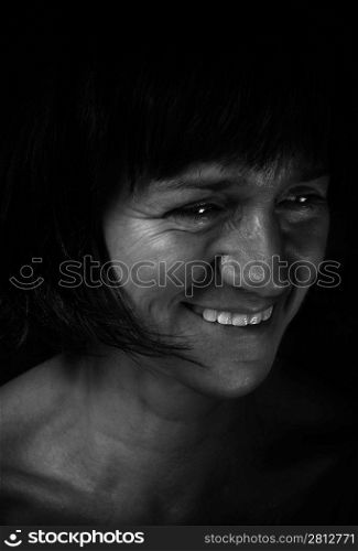 Smiling woman in black and white processed with lightpainting.