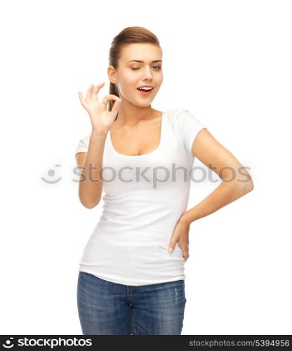 smiling woman in blank white t-shirt showing ok gesture