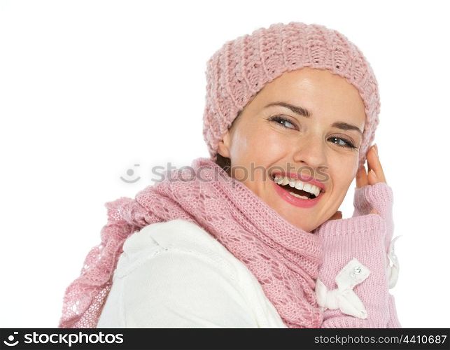 Smiling woman in knit winter clothes looking back on copy space