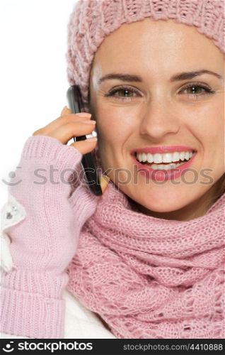 Smiling woman in knit winter clothing speaking mobile