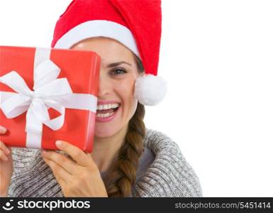 Smiling woman in Santa hat holding Christmas present