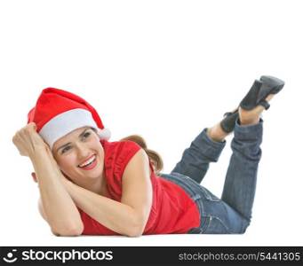 Smiling woman in Santa hat laying on floor and looking on copy space