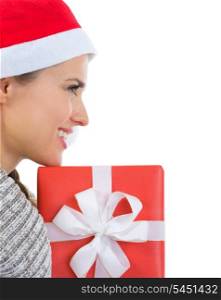 Smiling woman in Santa hat with Christmas gift box