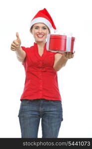 Smiling woman in Santa hat with Christmas present box showing thumbs up