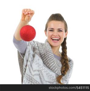 Smiling woman in sweater holding Christmas ball