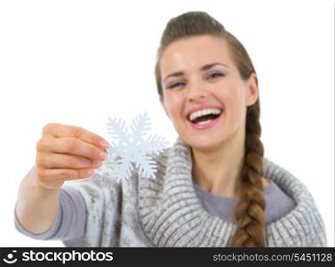 Smiling woman in sweater holding Christmas snowflake