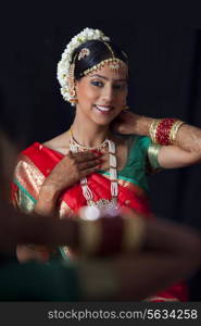 Smiling woman in traditional clothes getting ready