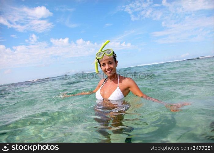 Smiling woman in water with snorkeling outfit