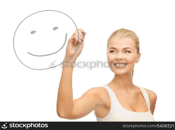smiling woman in white shirt drawing happy smile on glass